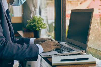 Man using laptop on table