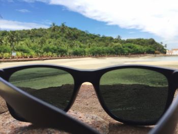 Close-up of sunglasses on road