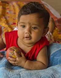 Portrait of cute baby playing with ball