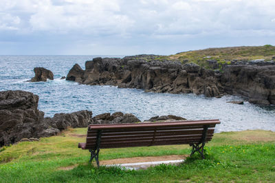 Nice view of a bench in front of the sea coast