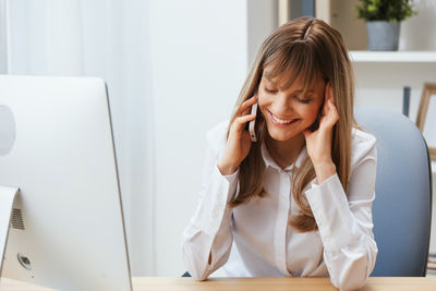 Young woman using laptop at home