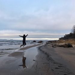 Full length of man on beach against sky