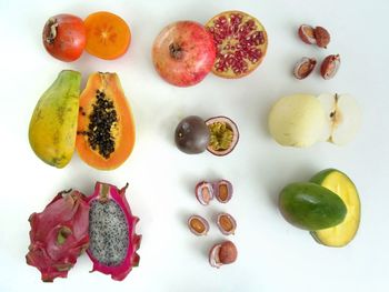 High angle view of chopped fruits against white background