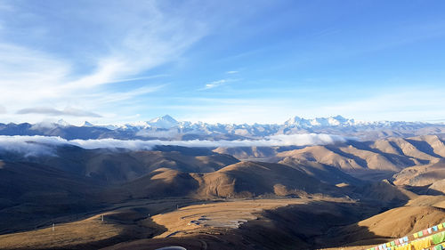 Scenic view of snowcapped mountains against blue sky