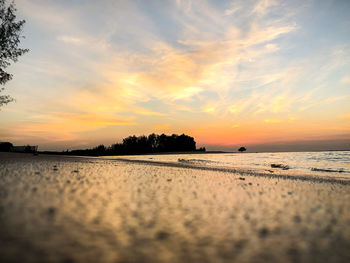 Scenic view of beach against sky during sunset