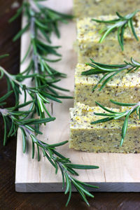 Close-up of rosemary and sliced polenta on cutting board