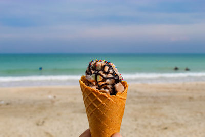 Close-up of ice cream on beach