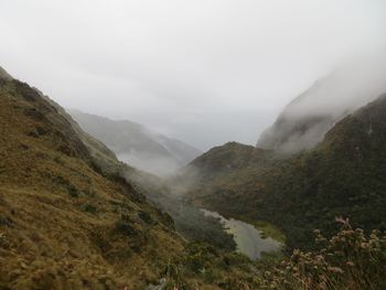 Scenic view of mountains against sky during foggy weather