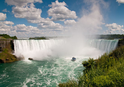 Small boat, maid of the mist, below the niagara falls, ontario, canada