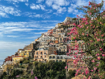 High angle view of townscape by sea against sky