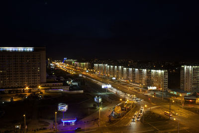 Illuminated cityscape against sky at night