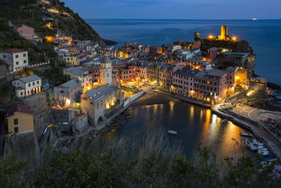 High angle view of illuminated buildings at waterfront