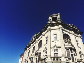 Low angle view of building against clear blue sky