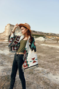 Rear view of woman standing against sky