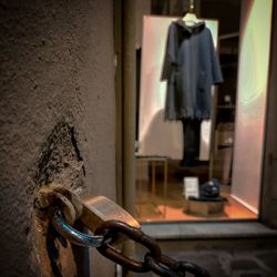 Close-up of bicycle hanging against wall in building