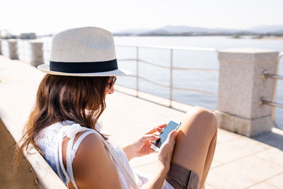 Rear view of woman using mobile phone