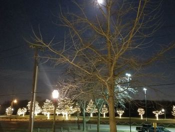 Low angle view of illuminated street light at night