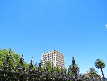 Low angle view of trees and building against sky