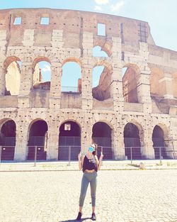 Full length of woman standing at historic building