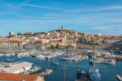 Sailboats in city at waterfront