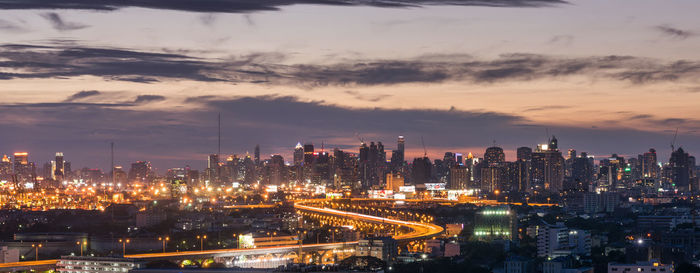 High angle view of illuminated buildings against sky at night