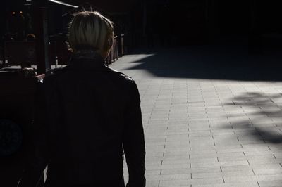 Rear view of woman standing at night