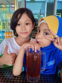 Portrait of girls gesturing in cafe