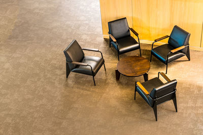 High angle view of empty chairs and table