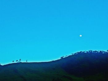 Low angle view of mountains against clear blue sky