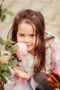 Portrait of cute girl holding flowers