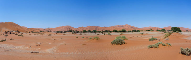 Scenic view of desert against clear blue sky