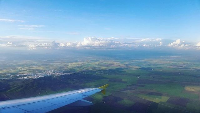 airplane, transportation, air vehicle, aircraft wing, flying, aerial view, mode of transport, landscape, part of, cropped, mid-air, sky, blue, travel, scenics, journey, on the move, beauty in nature, nature, public transportation