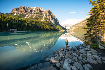 Hiker standing at the edge of lake louise in banff national park