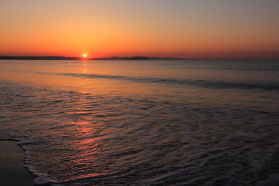 Scenic view of sea against romantic sky at sunset