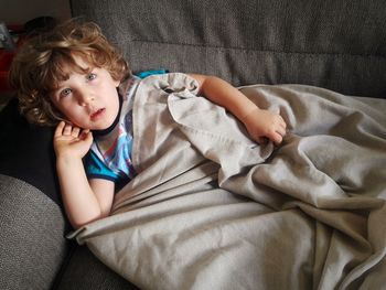 Portrait of cute baby lying on sofa