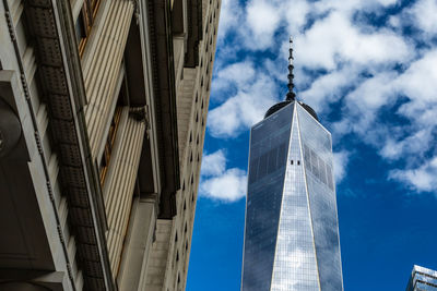 Low angle view of buildings against cloudy sky