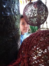 Portrait of cute girl with tree trunk