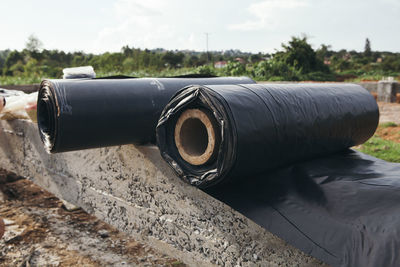 Rolled up tarpaulin on cement wall