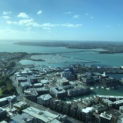 High angle view of townscape by sea against sky