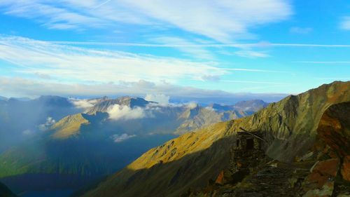 Scenic view of mountains against cloudy sky