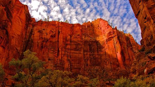 Low angle view of rock formation against cloudy sky