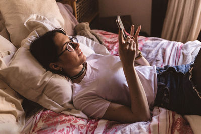 High angle view of man sleeping on bed at home