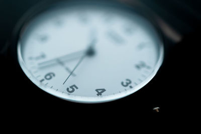 Close-up of clock against black background