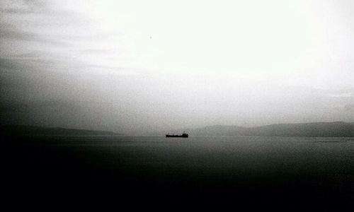 Scenic view of boats in sea against sky