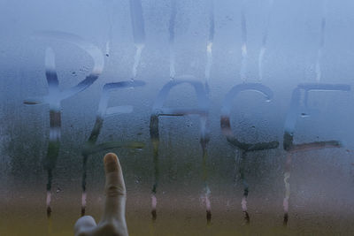 Low section of man standing in water