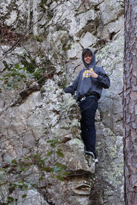 Low angle view of man standing on rock