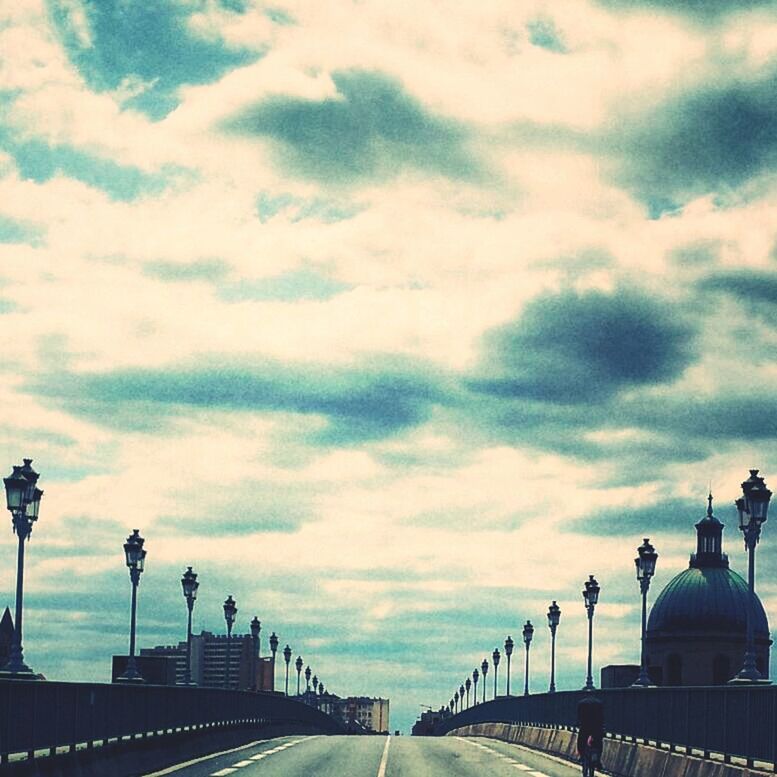 architecture, built structure, sky, low angle view, cloud - sky, railing, building exterior, the way forward, street light, cloudy, cloud, diminishing perspective, connection, incidental people, travel destinations, famous place, vanishing point, outdoors, in a row, travel