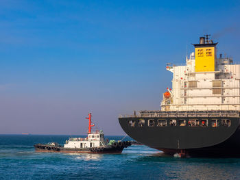 Ship in sea against blue sky