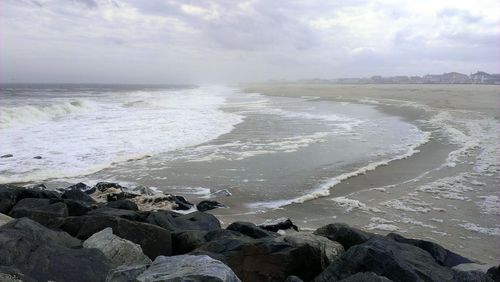 Scenic view of sea against cloudy sky