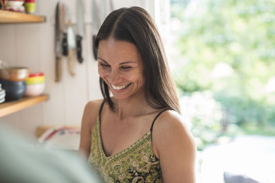 Cheerful woman in kitchen at home